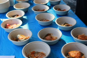 Servings of chile relleno are dished out in compostable bowls.