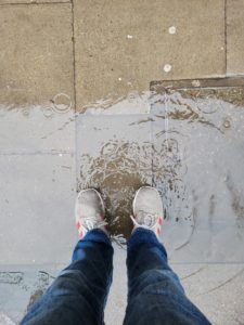 I stand in a puddle while I wait to cross the road.